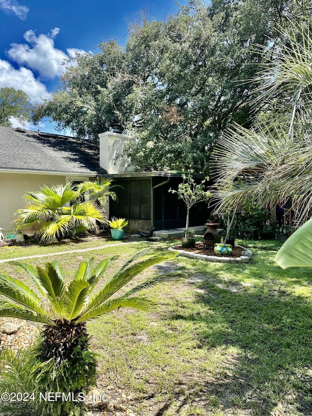 view of yard with a sunroom