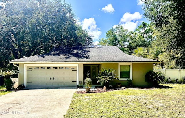 ranch-style house with stucco siding, concrete driveway, an attached garage, a front yard, and fence