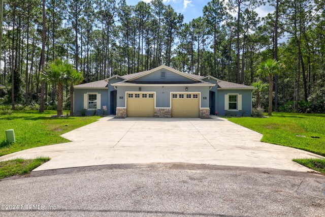 view of front facade with a garage and a front yard