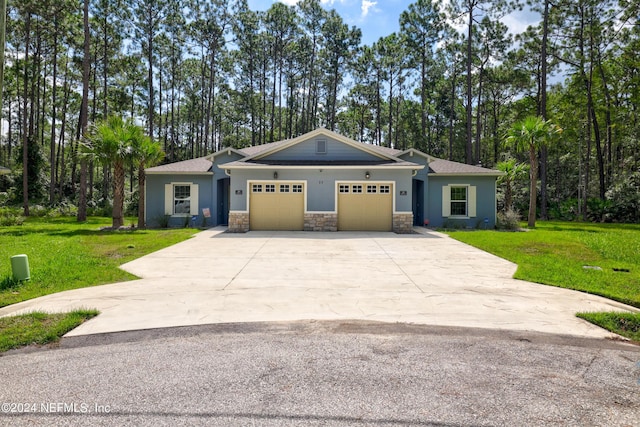 view of front of home featuring a garage, stone siding, driveway, and a front lawn