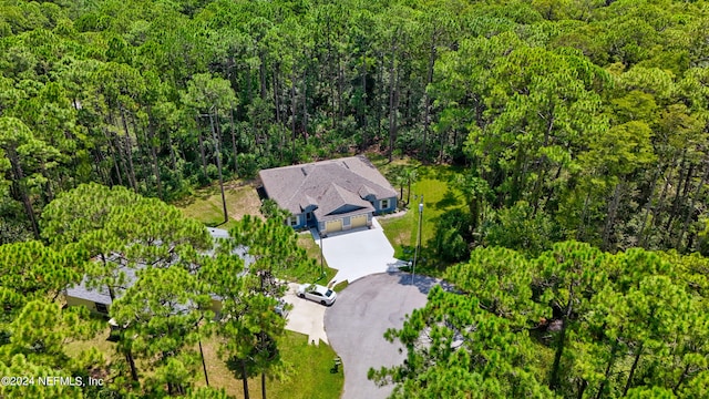 aerial view featuring a wooded view