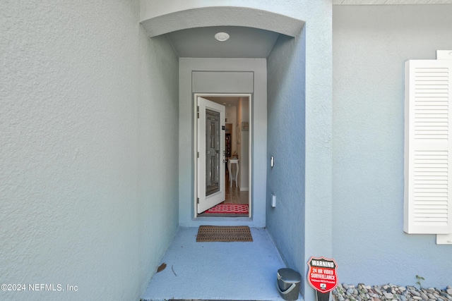 property entrance featuring stucco siding