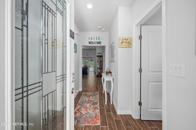 corridor with wood tiled floor and baseboards