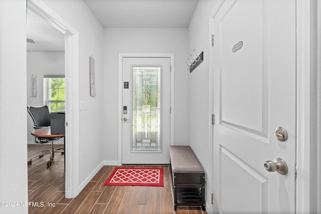 doorway to outside featuring dark wood finished floors and baseboards