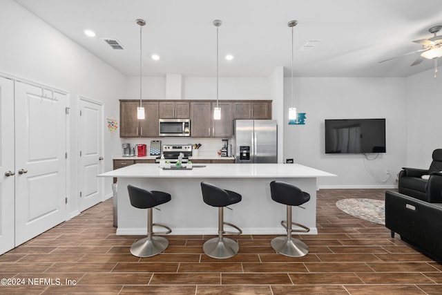 kitchen with wood tiled floor, visible vents, stainless steel appliances, and light countertops