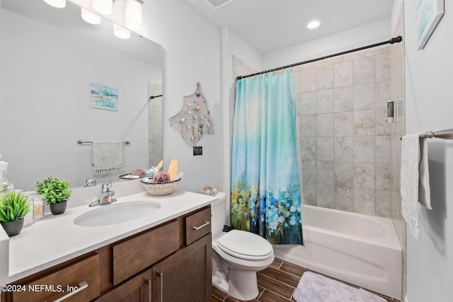 bathroom with wood finish floors, visible vents, toilet, shower / bath combo with shower curtain, and vanity