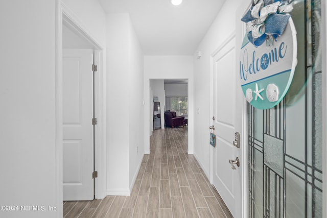 hall with wood finish floors and baseboards