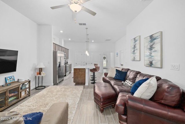 living room with ceiling fan, recessed lighting, visible vents, baseboards, and wood tiled floor