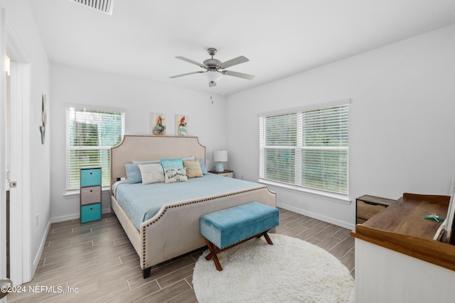 bedroom with wood finish floors, ceiling fan, and baseboards