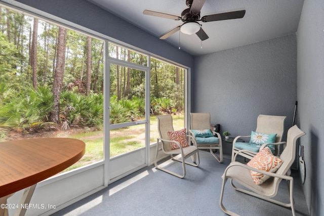 sunroom / solarium featuring a healthy amount of sunlight and a ceiling fan