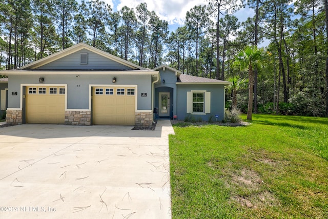 view of front of home with concrete driveway, stucco siding, an attached garage, and a front yard