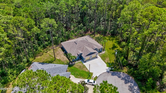 aerial view featuring a wooded view