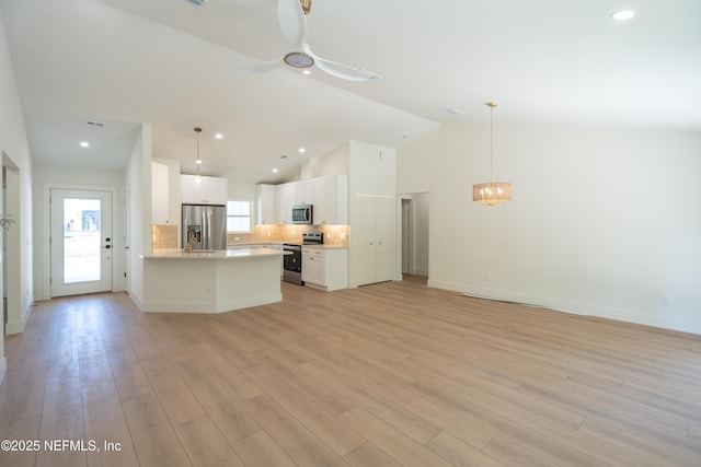 411 Royal Rd, Saint Augustine South, FL 32086 - kitchen with appliances with stainless steel finishes, open floor plan, white cabinetry, a chandelier, and light countertops