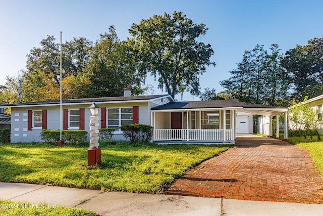 ranch-style home with a front lawn, a carport, and covered porch