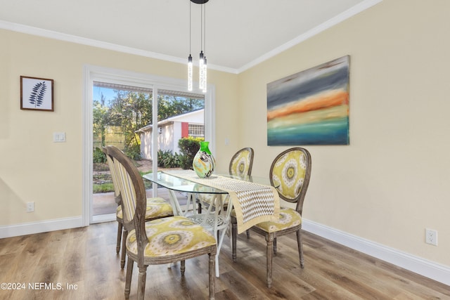 dining room featuring crown molding and hardwood / wood-style flooring