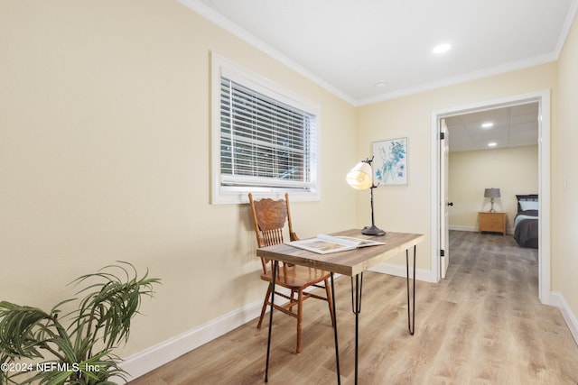 office area featuring light wood-type flooring and ornamental molding