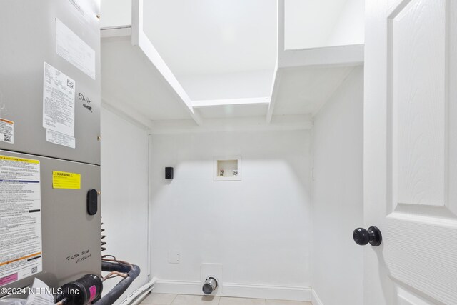 interior space featuring washer hookup, heating unit, light tile patterned floors, and electric dryer hookup