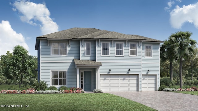 view of front of house featuring a garage and a front lawn