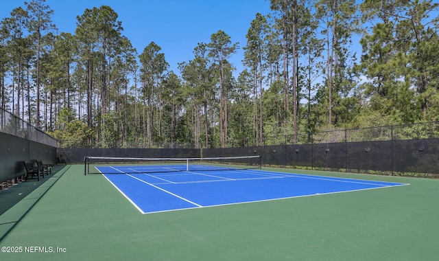 view of tennis court featuring basketball hoop