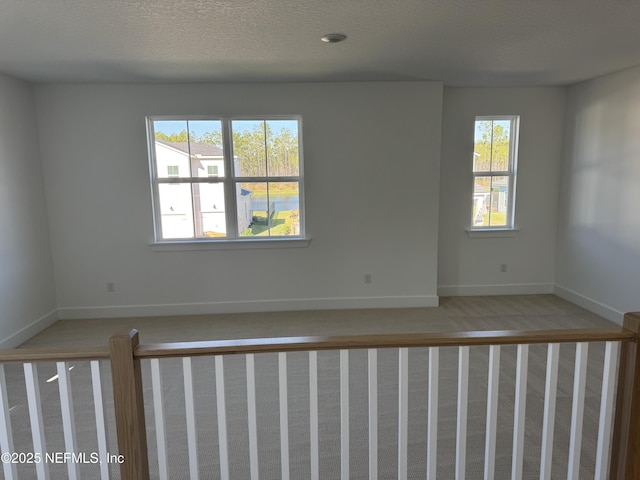 unfurnished room with a textured ceiling