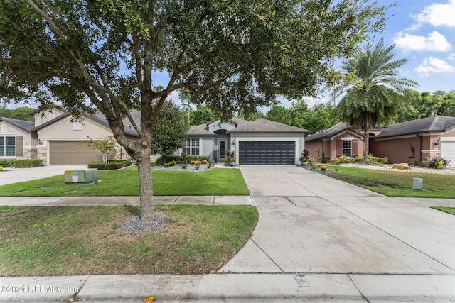 ranch-style home featuring a garage and a front lawn