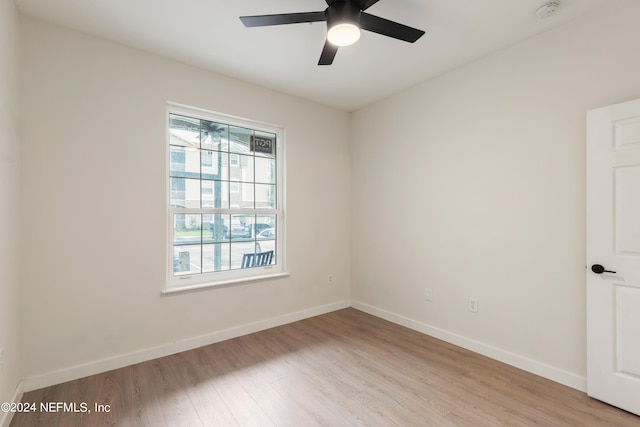 empty room with light wood-type flooring and ceiling fan