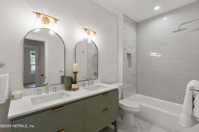 full bathroom featuring tiled shower / bath, vanity, and toilet