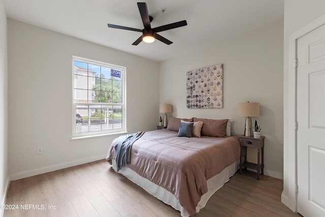 bedroom with ceiling fan and hardwood / wood-style floors