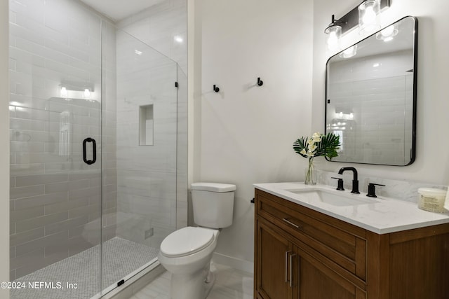 bathroom featuring vanity, toilet, and an enclosed shower