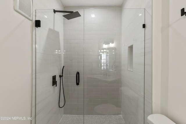 bathroom with toilet and an enclosed shower