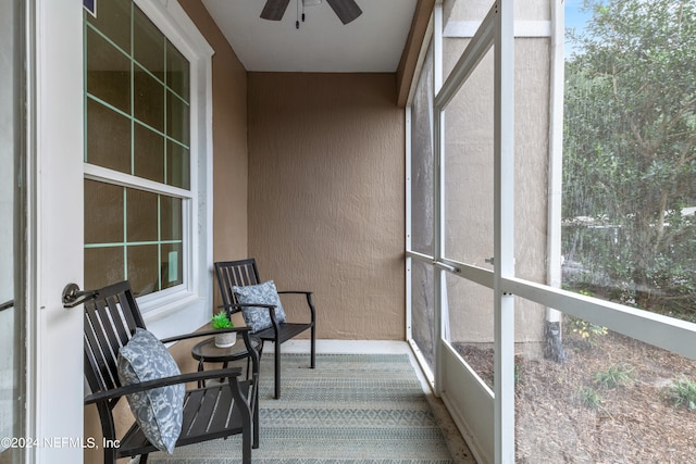 sunroom featuring ceiling fan