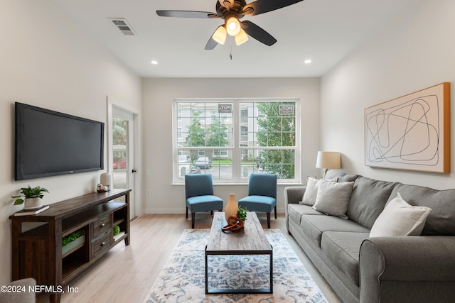 living room with ceiling fan and light hardwood / wood-style flooring