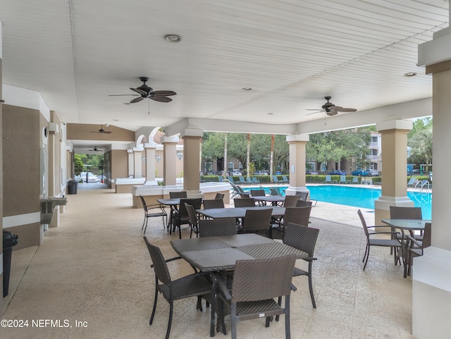 view of patio / terrace with ceiling fan and a community pool