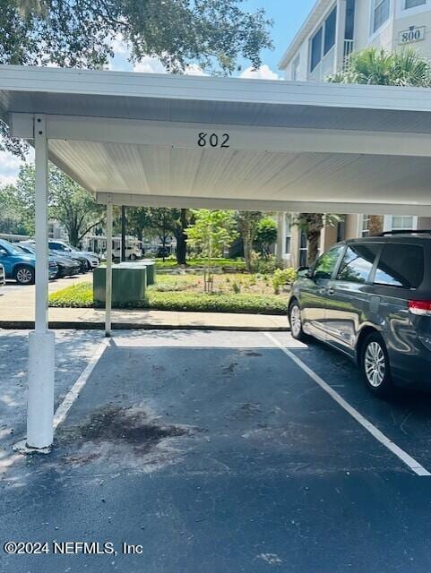 view of vehicle parking with a carport