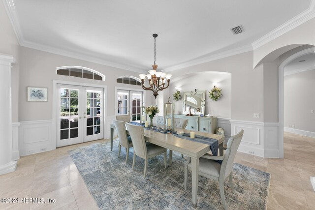 dining room featuring light tile patterned flooring, ornamental molding, a notable chandelier, and french doors