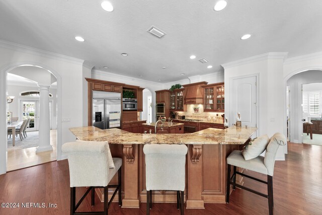 kitchen with a healthy amount of sunlight, appliances with stainless steel finishes, and dark wood-type flooring