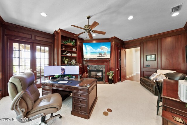 office space with a premium fireplace, ceiling fan, ornamental molding, and french doors