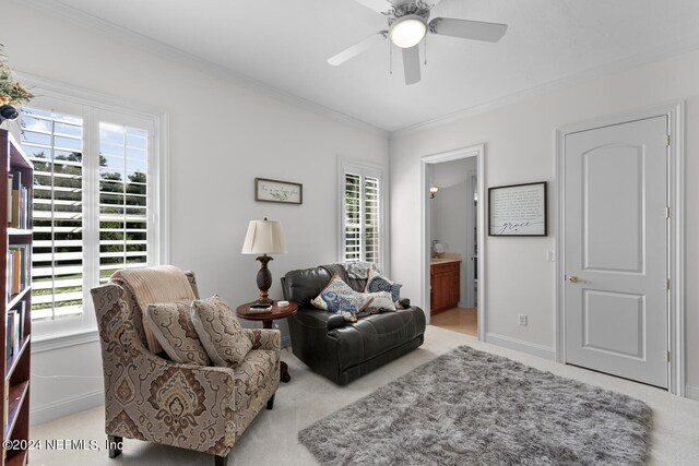 carpeted living room with ornamental molding, a wealth of natural light, and ceiling fan