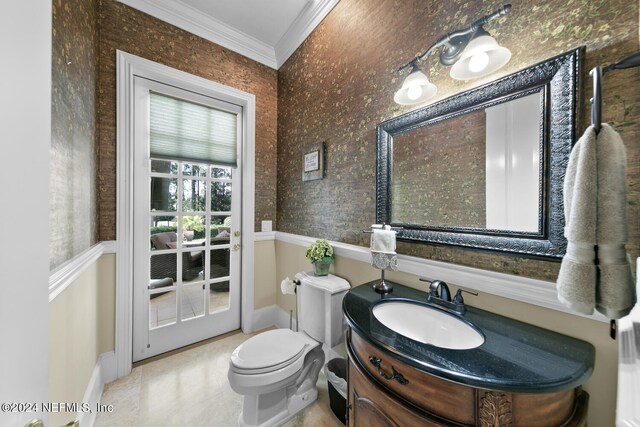 bathroom featuring vanity, toilet, ornamental molding, and tile patterned floors