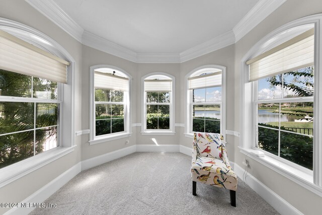 sunroom / solarium featuring a water view