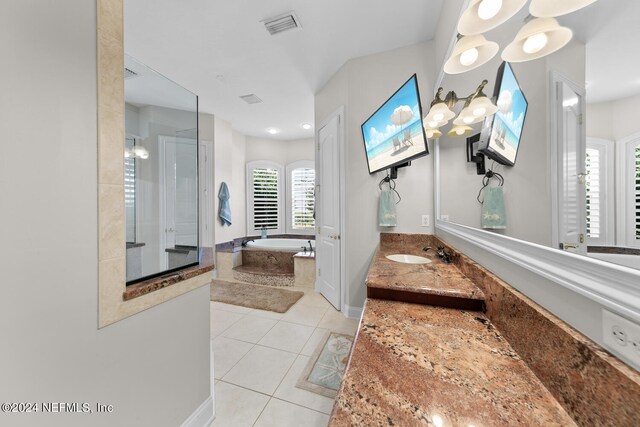 bathroom featuring tile patterned flooring, shower with separate bathtub, an inviting chandelier, and vanity