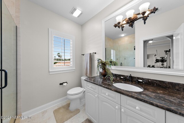 bathroom featuring tile patterned floors, toilet, an enclosed shower, and vanity