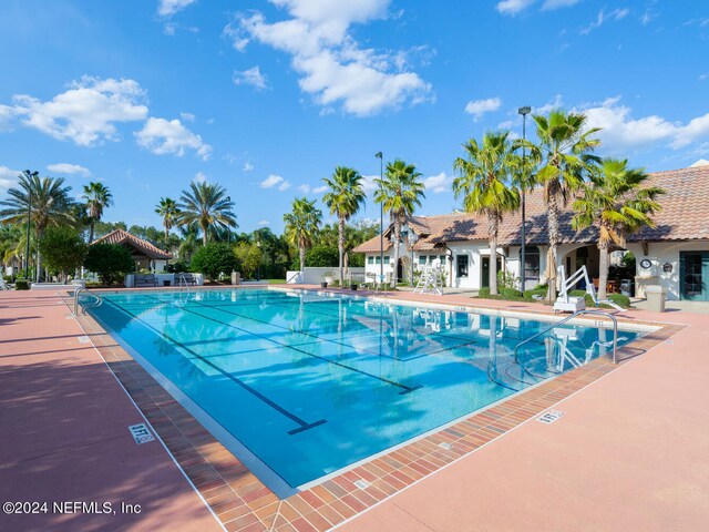 view of swimming pool with a patio