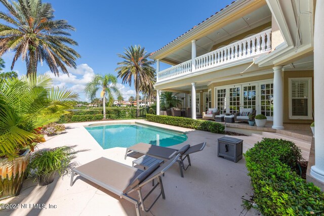 view of pool with an outdoor living space and a patio