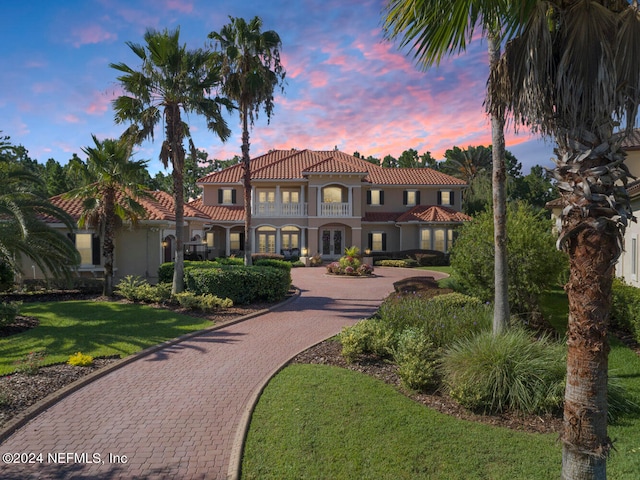 mediterranean / spanish-style home featuring a yard