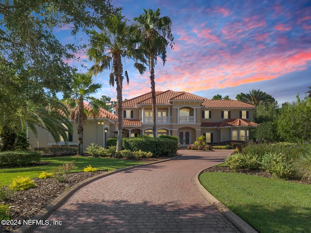 mediterranean / spanish-style home featuring a yard