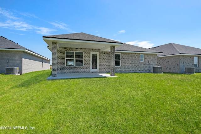 back of house with cooling unit, a yard, and a patio area