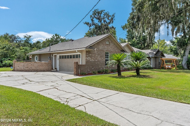 single story home with brick siding, roof with shingles, an attached garage, a front yard, and driveway