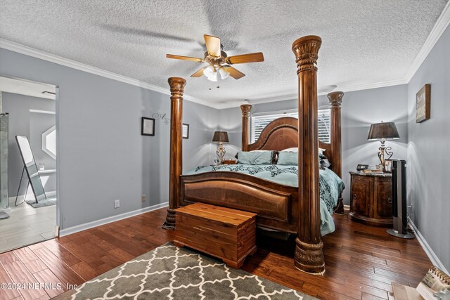 bedroom with dark wood-type flooring, ceiling fan, ornamental molding, and a textured ceiling