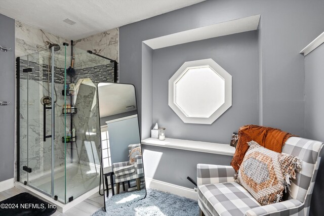 bathroom featuring a shower with door and tile patterned flooring